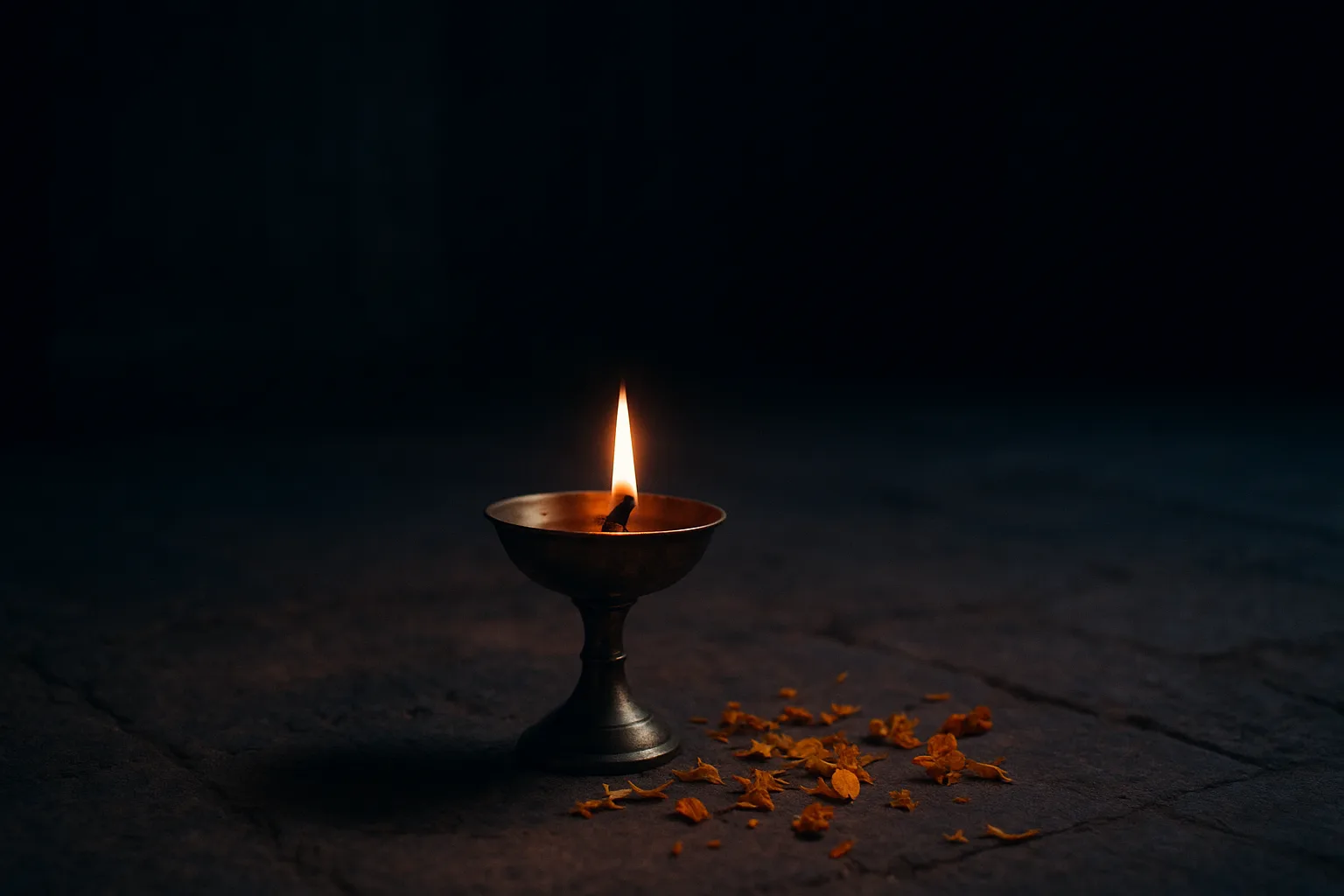 A brass oil lamp burning in a quiet room before dawn